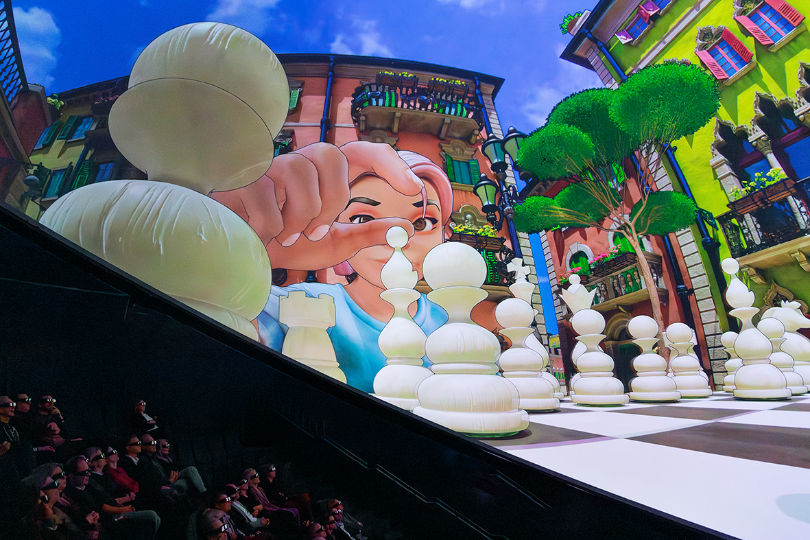 Visitors wearing 3D glasses watch a colourful animated chess scene projected onto the giant dome screen at Wisdome Stockholm.