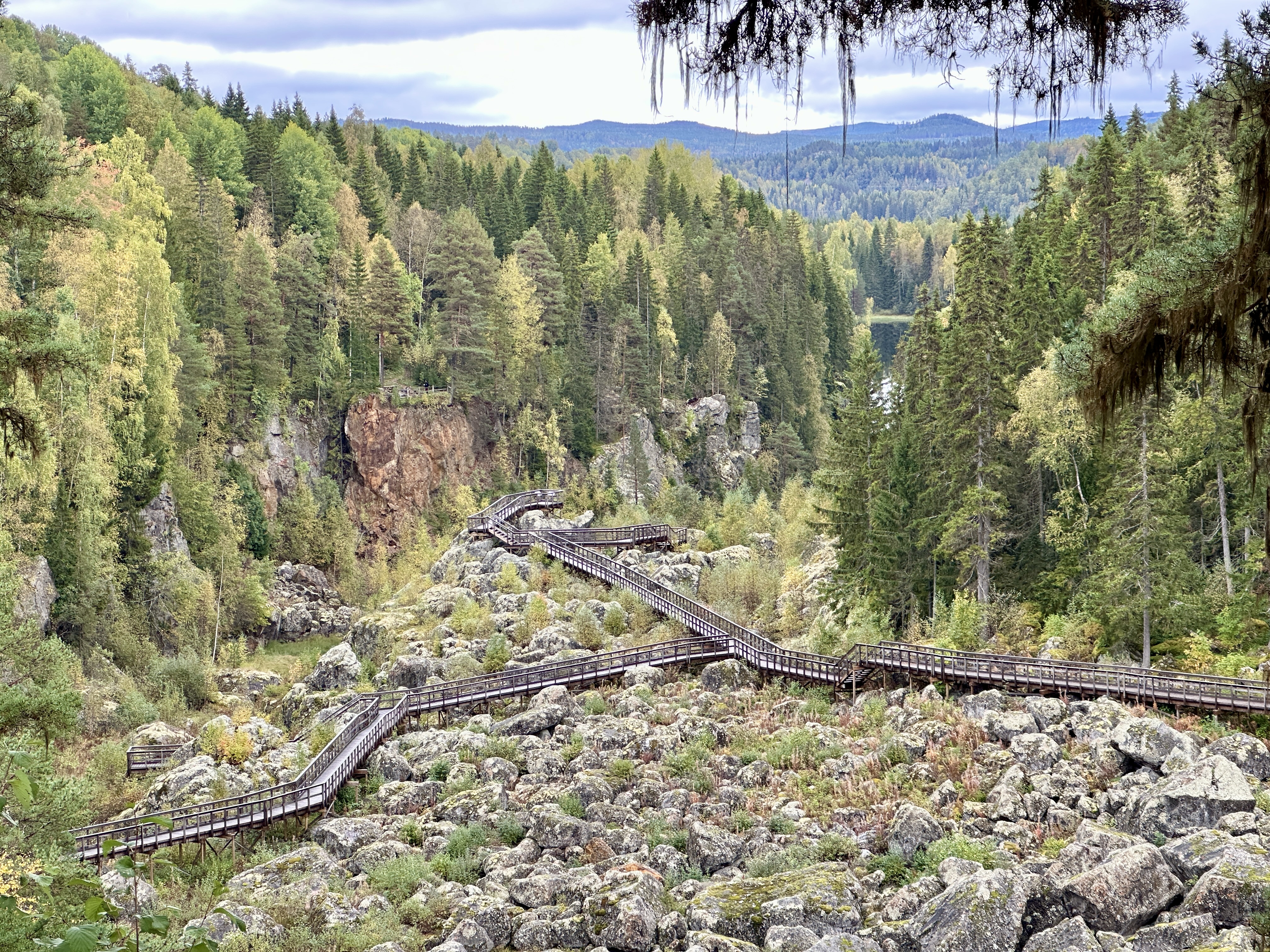 Wooden walkways winding through a rocky, forested landscape at Döda fallet in Ragunda, where a former waterfall has run dry.