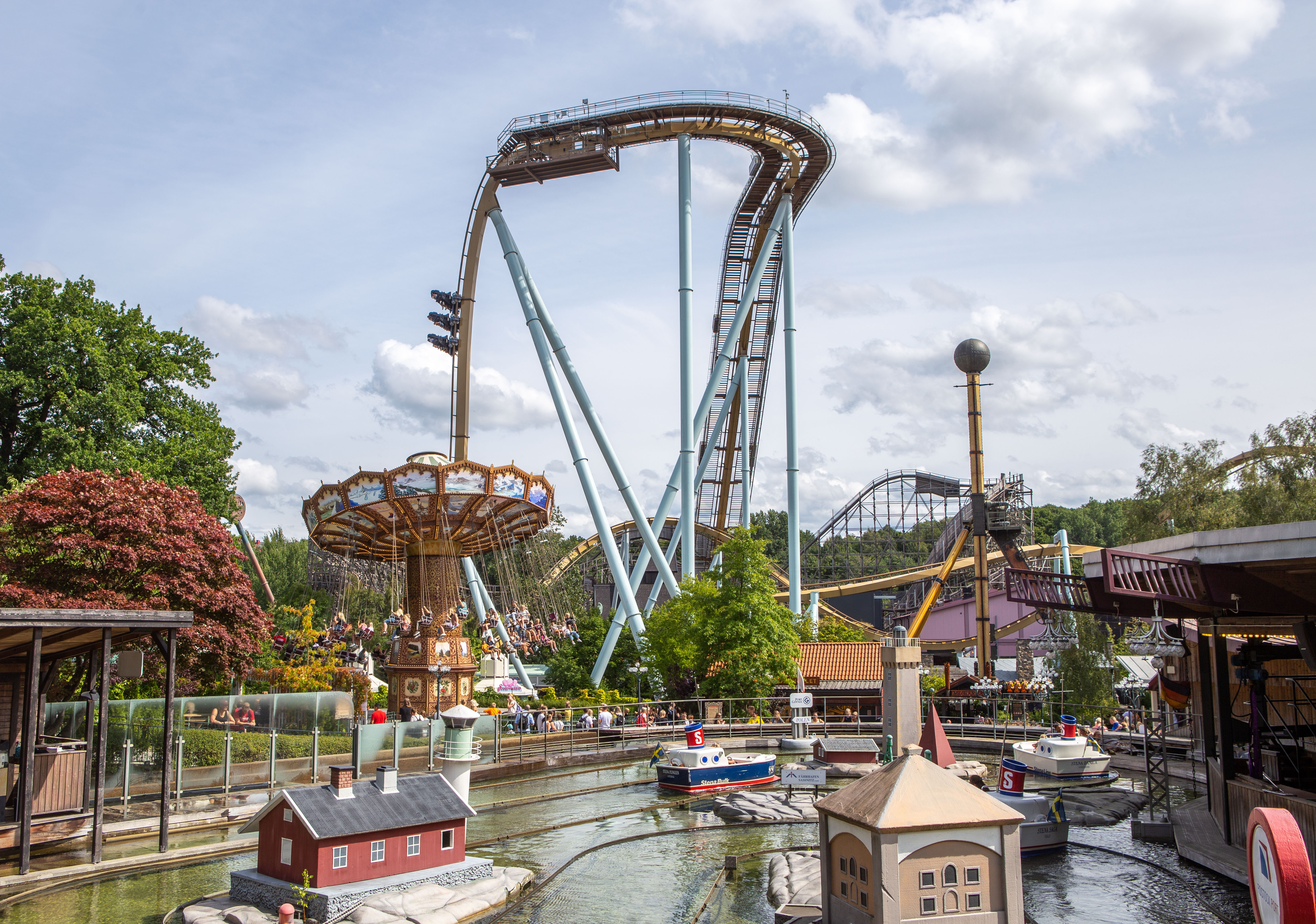 Roller coasters, rides and visitors enjoying Liseberg amusement park in Gothenburg.