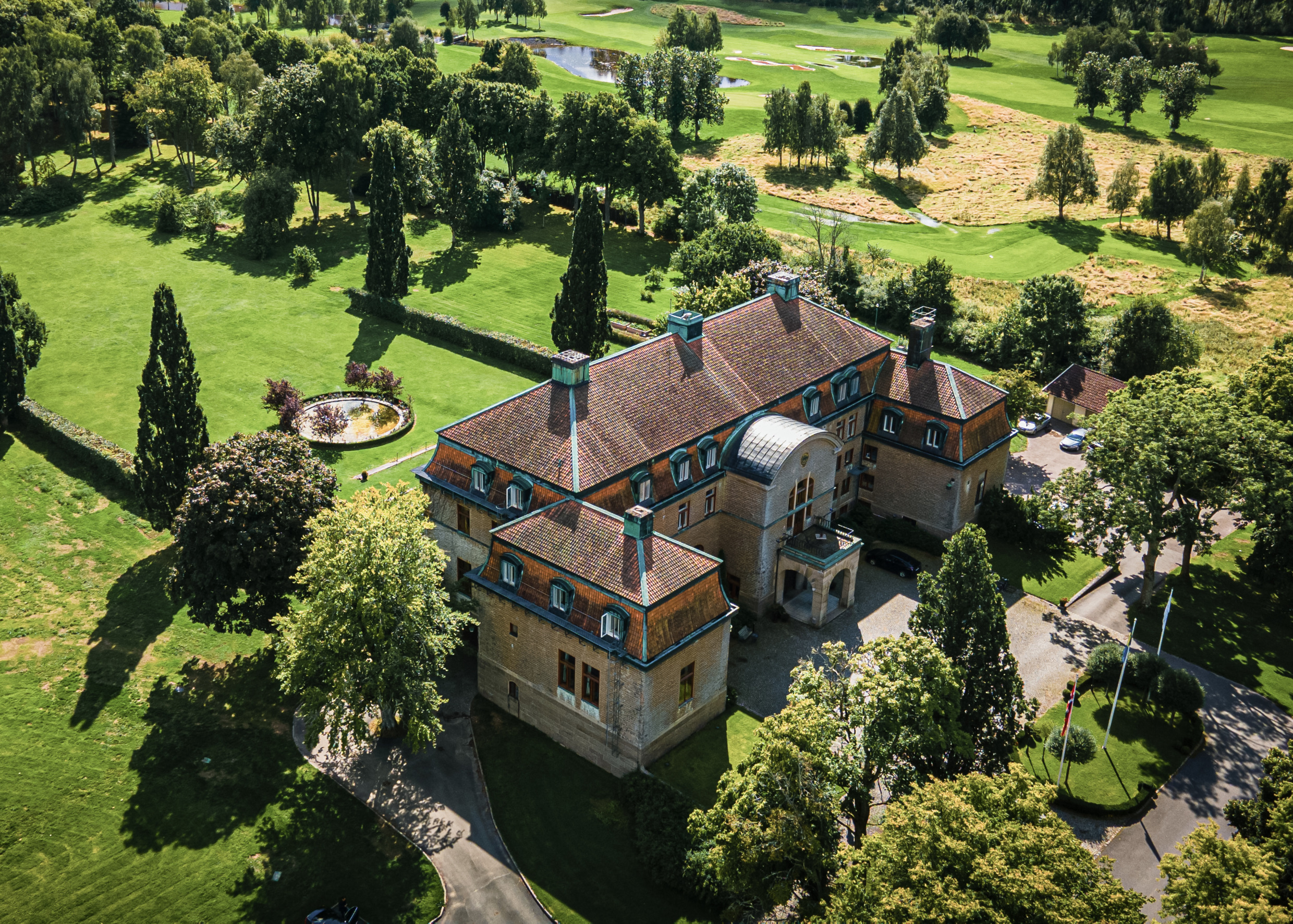 Bjertorp Castle in summer view over the castle and surrounding garden