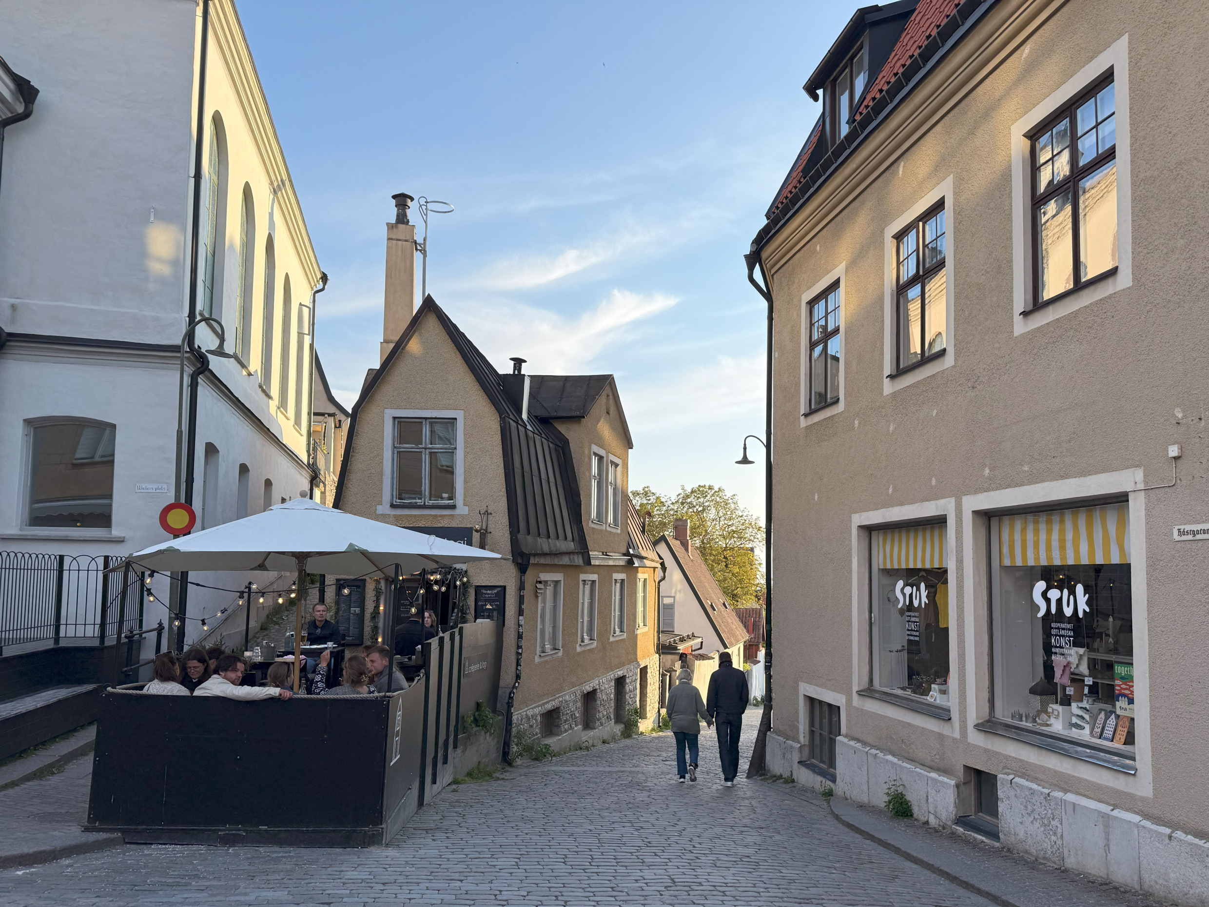 Outdoor diners at Crêperi & Logi in Visby, housed in a narrow, iron-shaped building famous for its galettes.