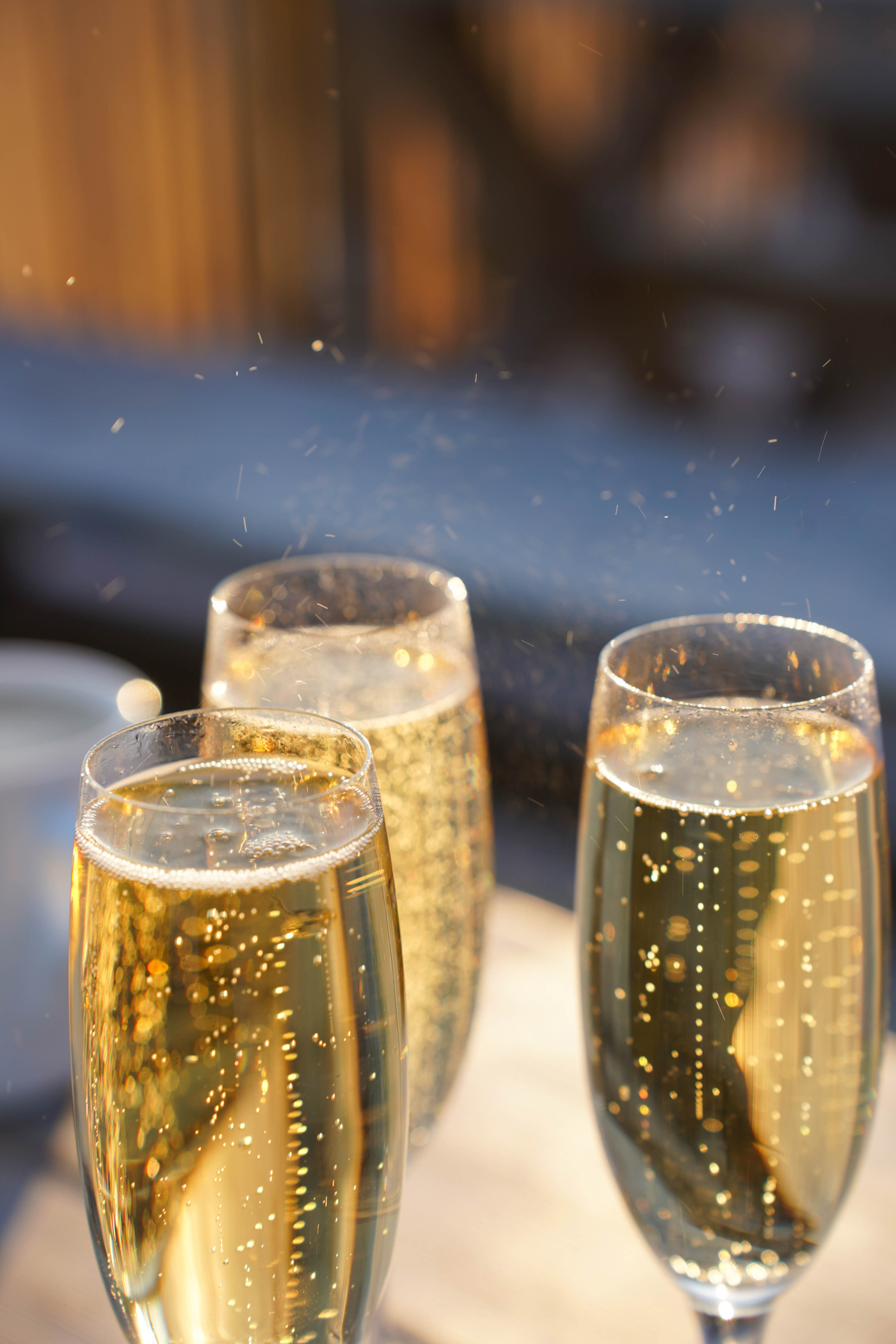hree champagne glasses filled with non-alcoholic sparkling wine.