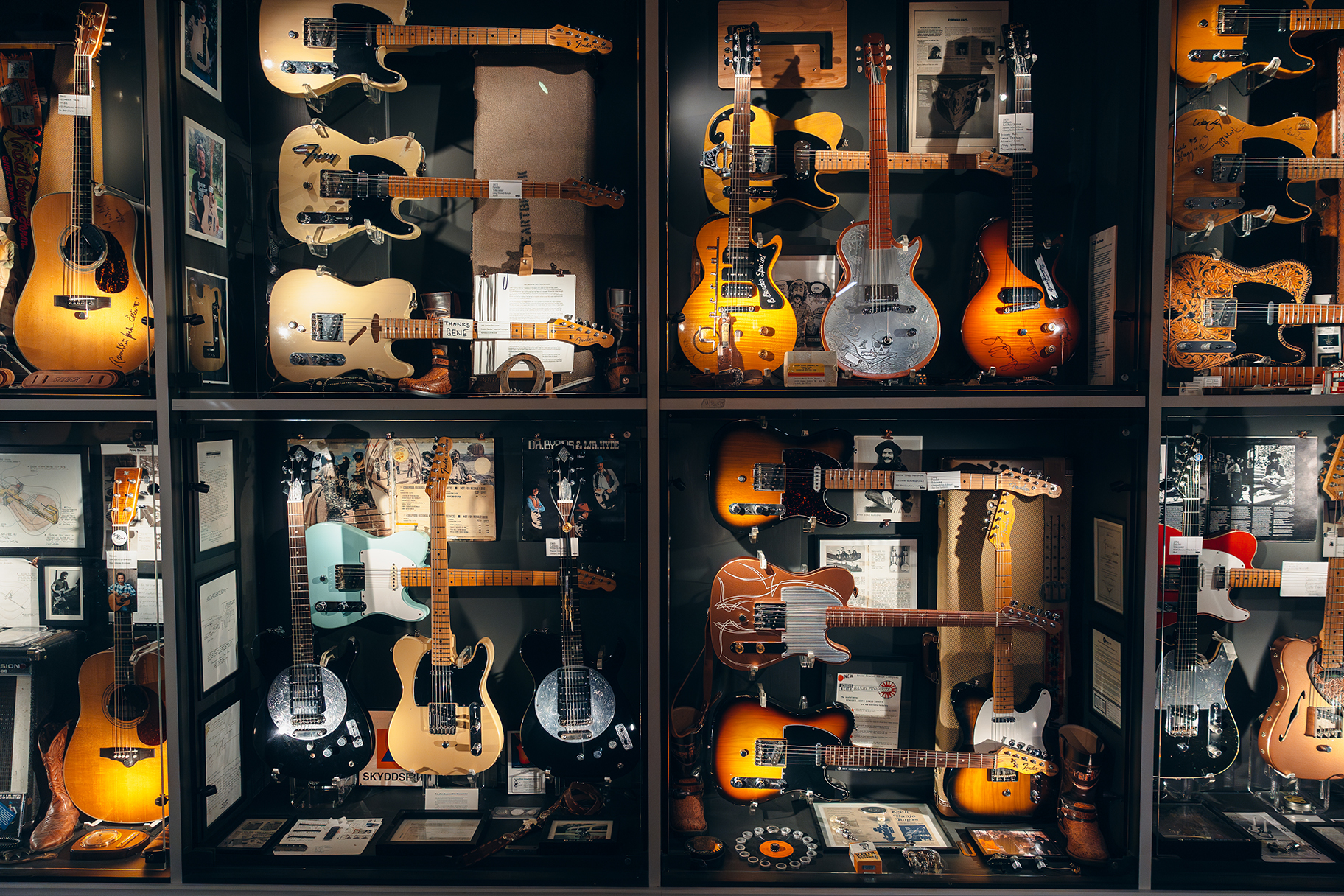 A display of vintage electric and acoustic guitars at Guitars – The Museum in Umeå.