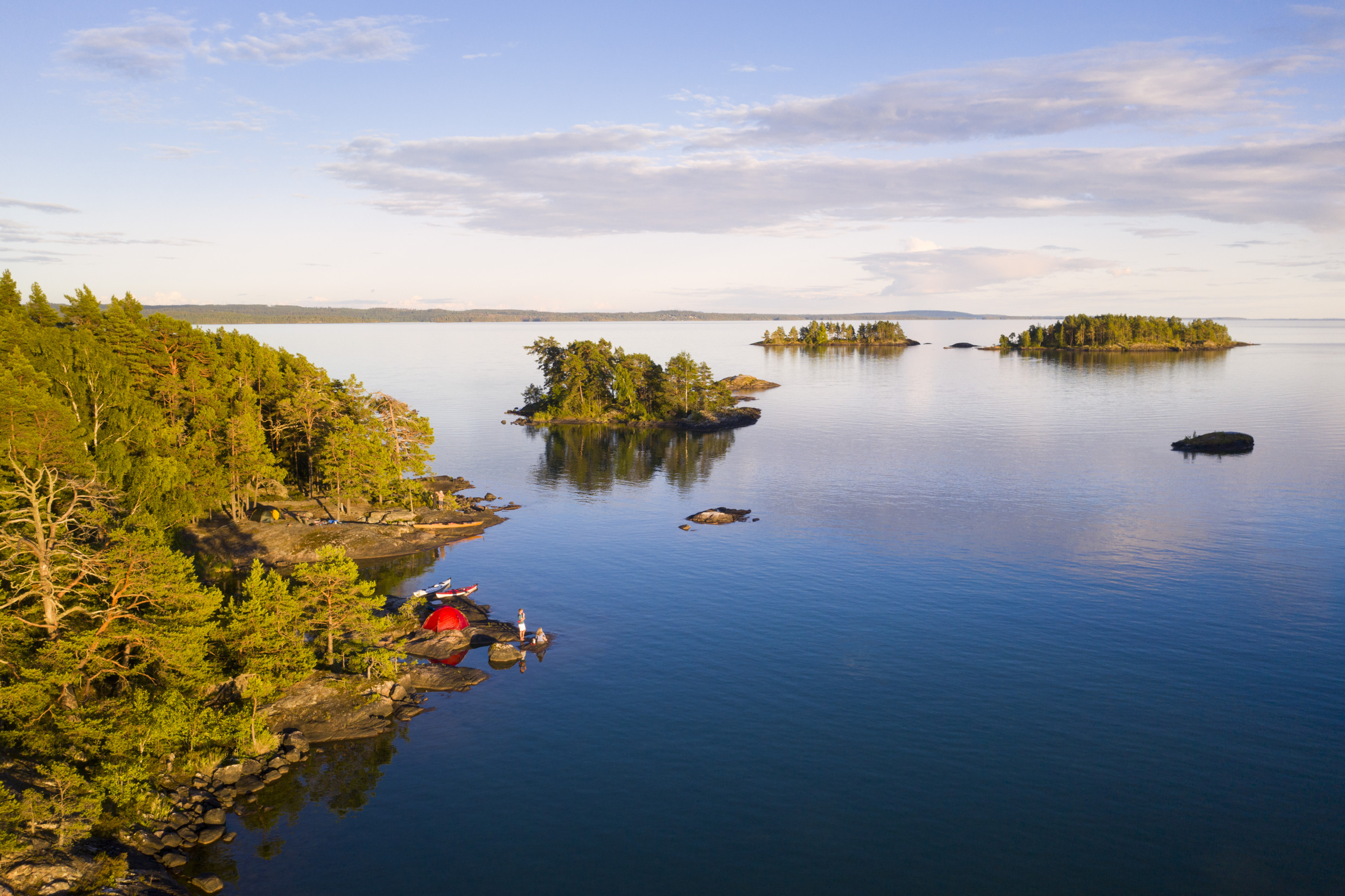 View of Lake Vättern. Some have pitched a red tent on one of the islands by the lake.