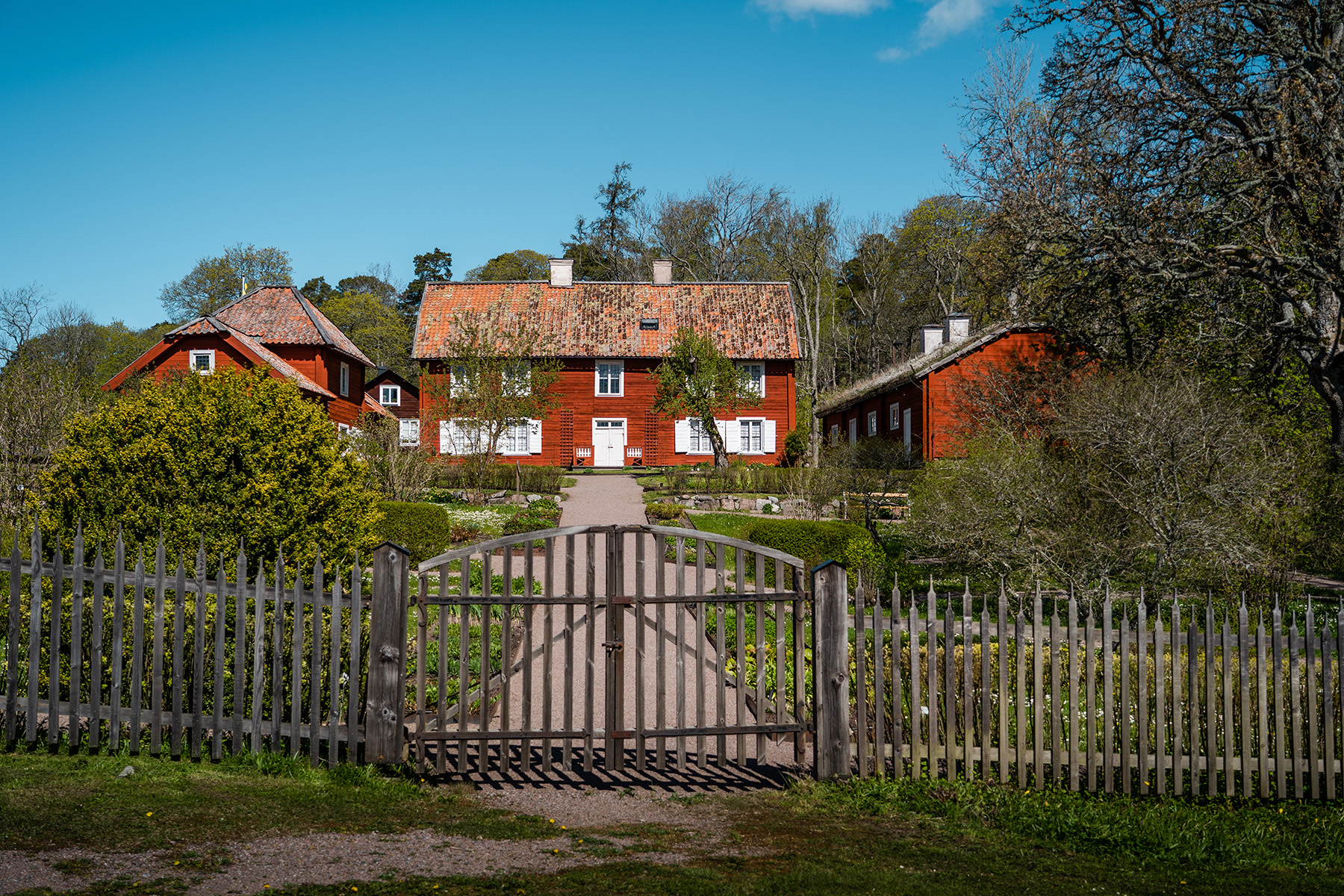 Traditional red wooden buildings at Linnaeus’ Hammarby outside Uppsala, Sweden.