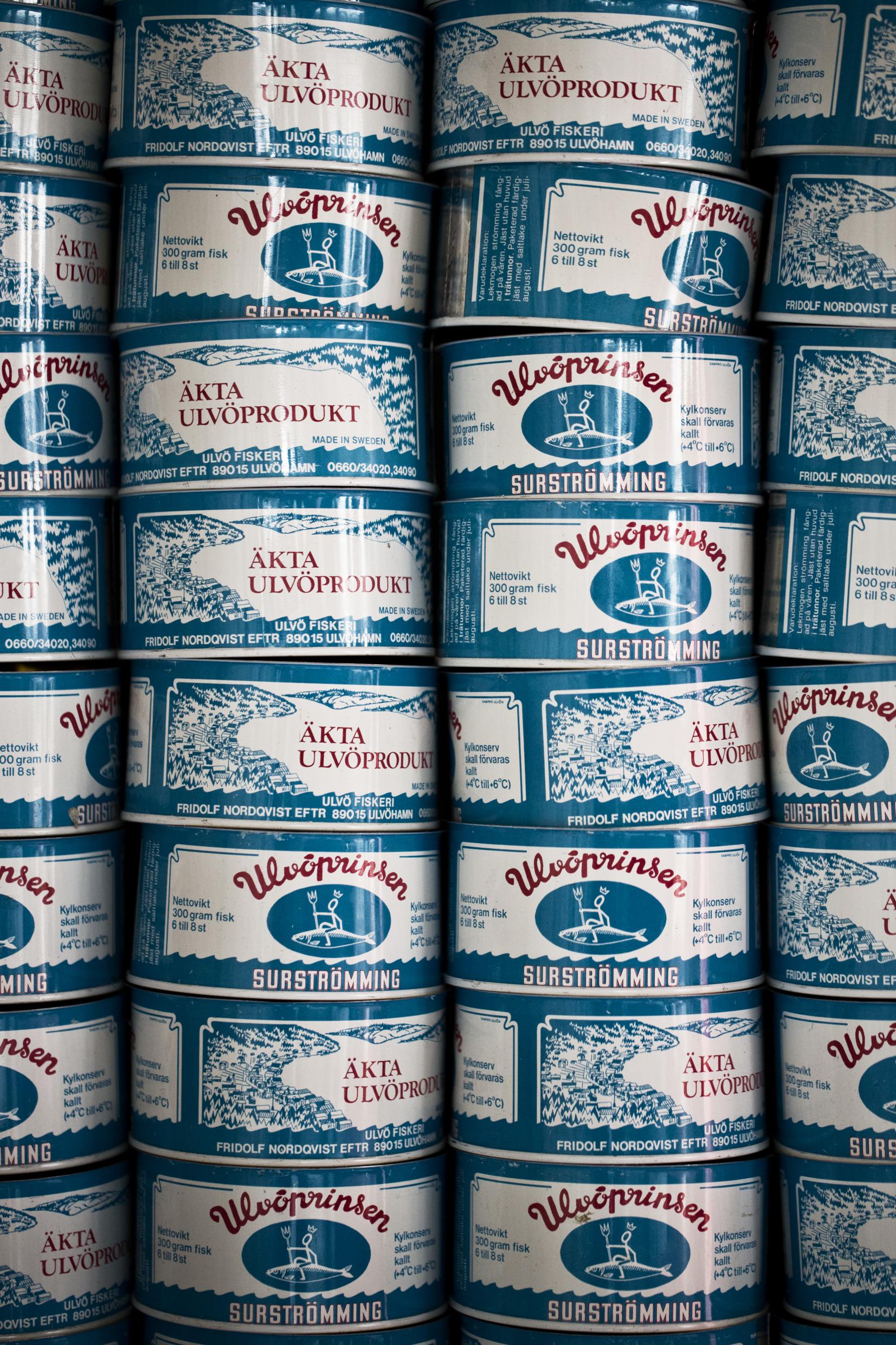 Cans of fermented herring stacked on top of each other in columns.