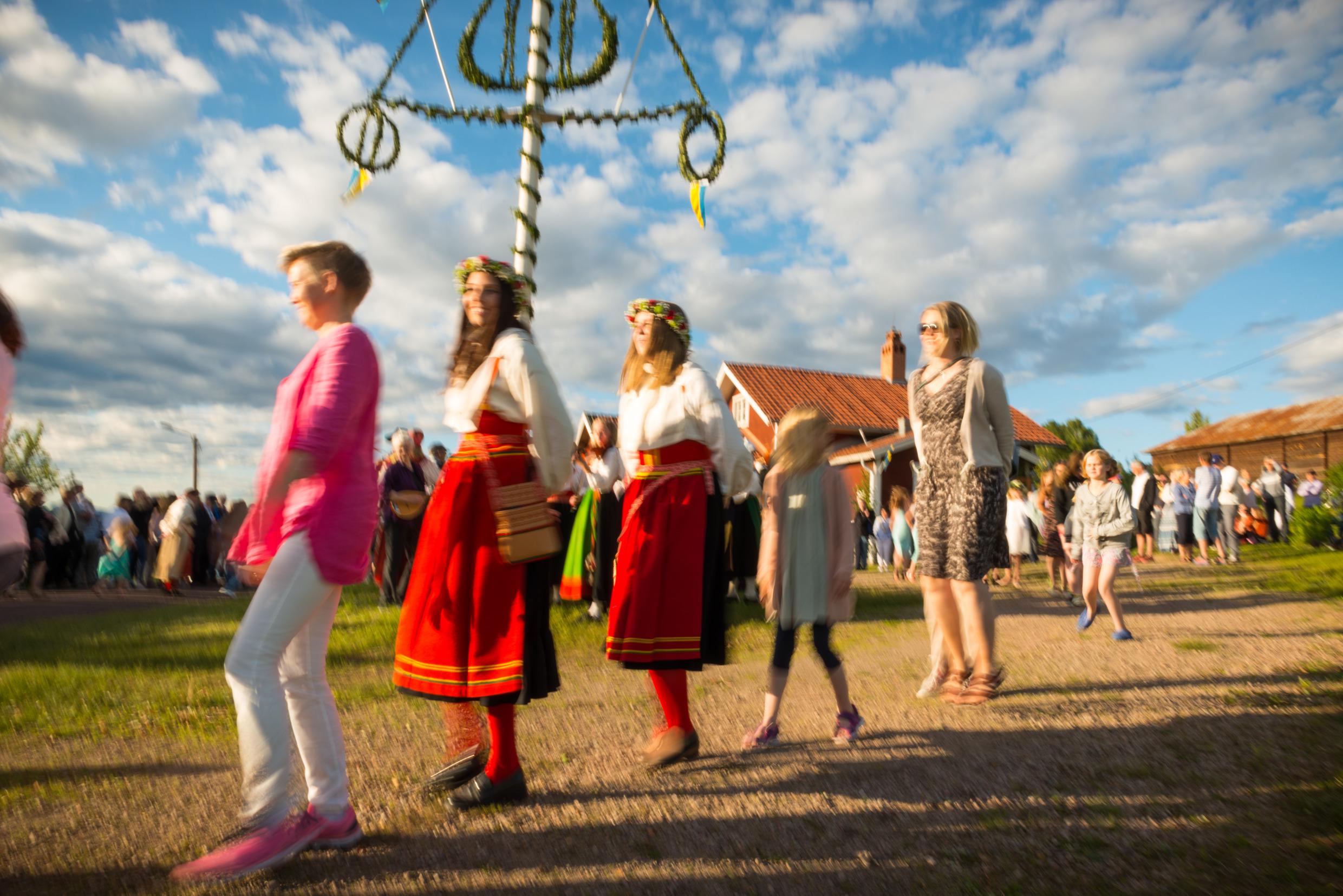 People dancing around the midsummer pole.