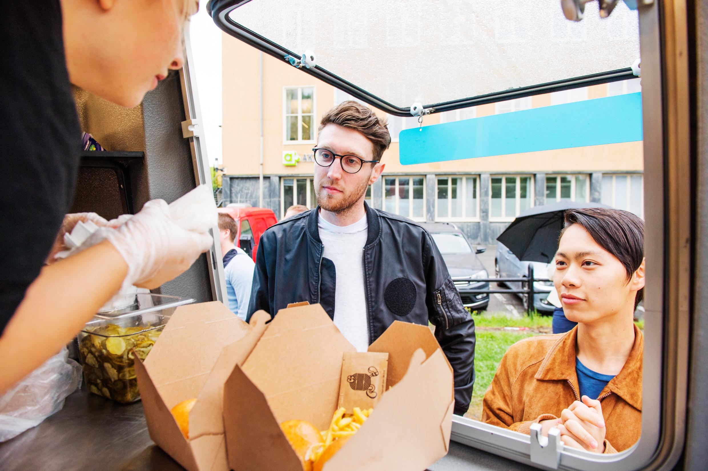 People order food at a Stockholm food truck.