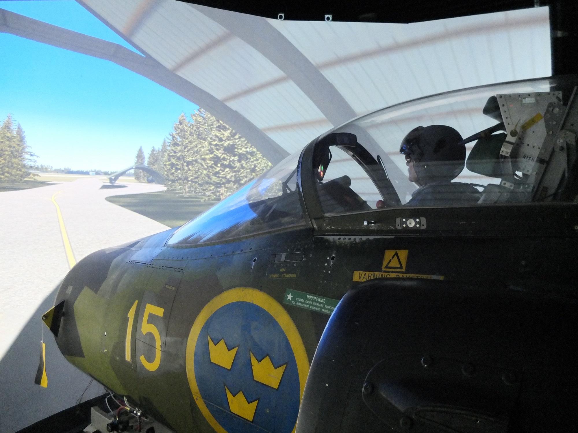 Person sitting in a Viggen flight simulator at F15 Flygmuseum in Söderhamn.