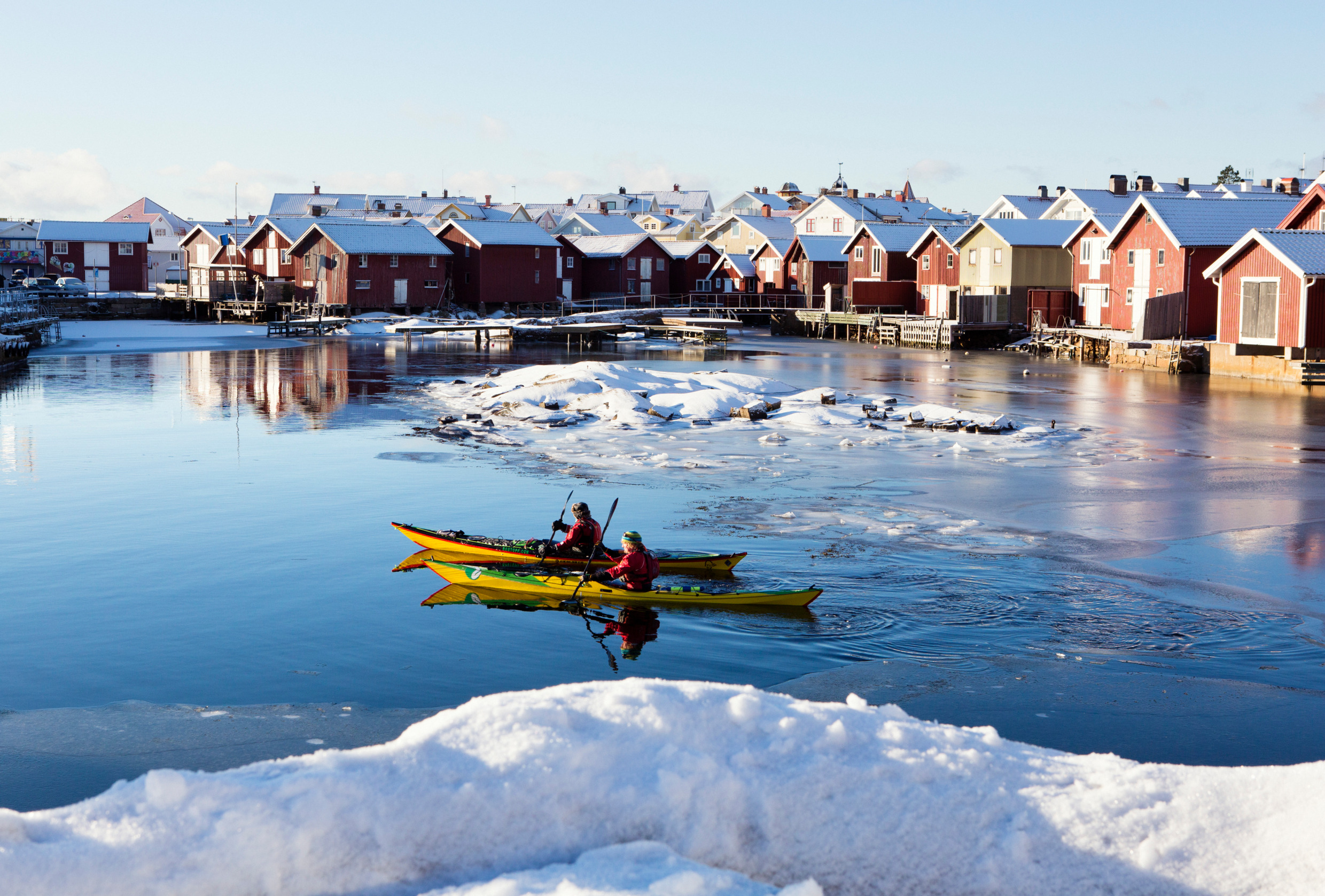 Two people kayaking during winter.