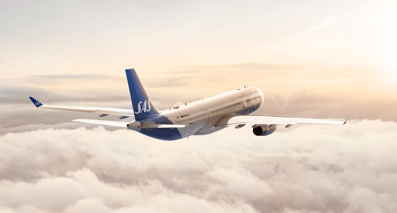 An airplane flies above the clouds.