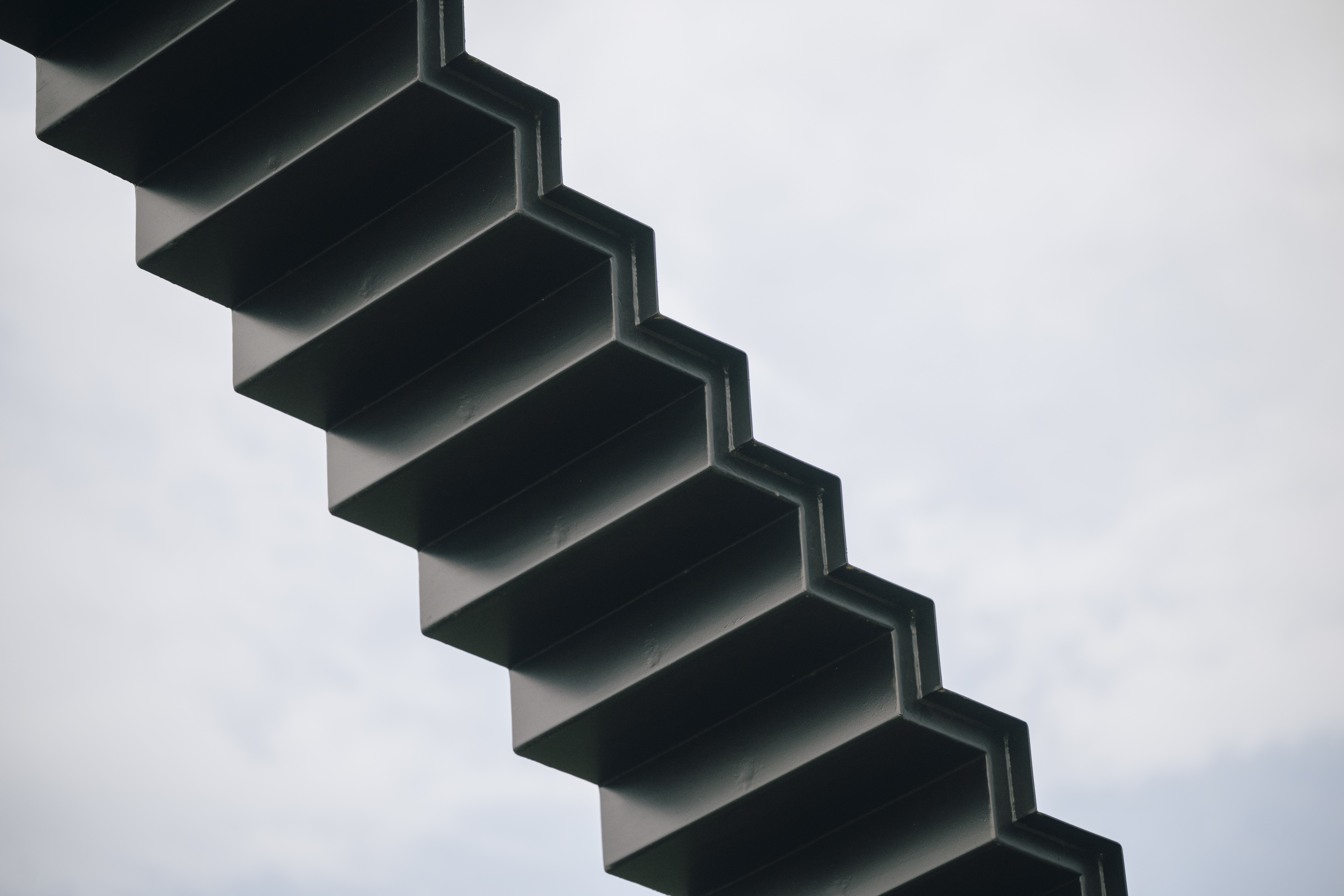 An architectural sculpture, 30 metres long and 18 metres high, made of black-painted steel set in a green area of Kivik Art Centre.