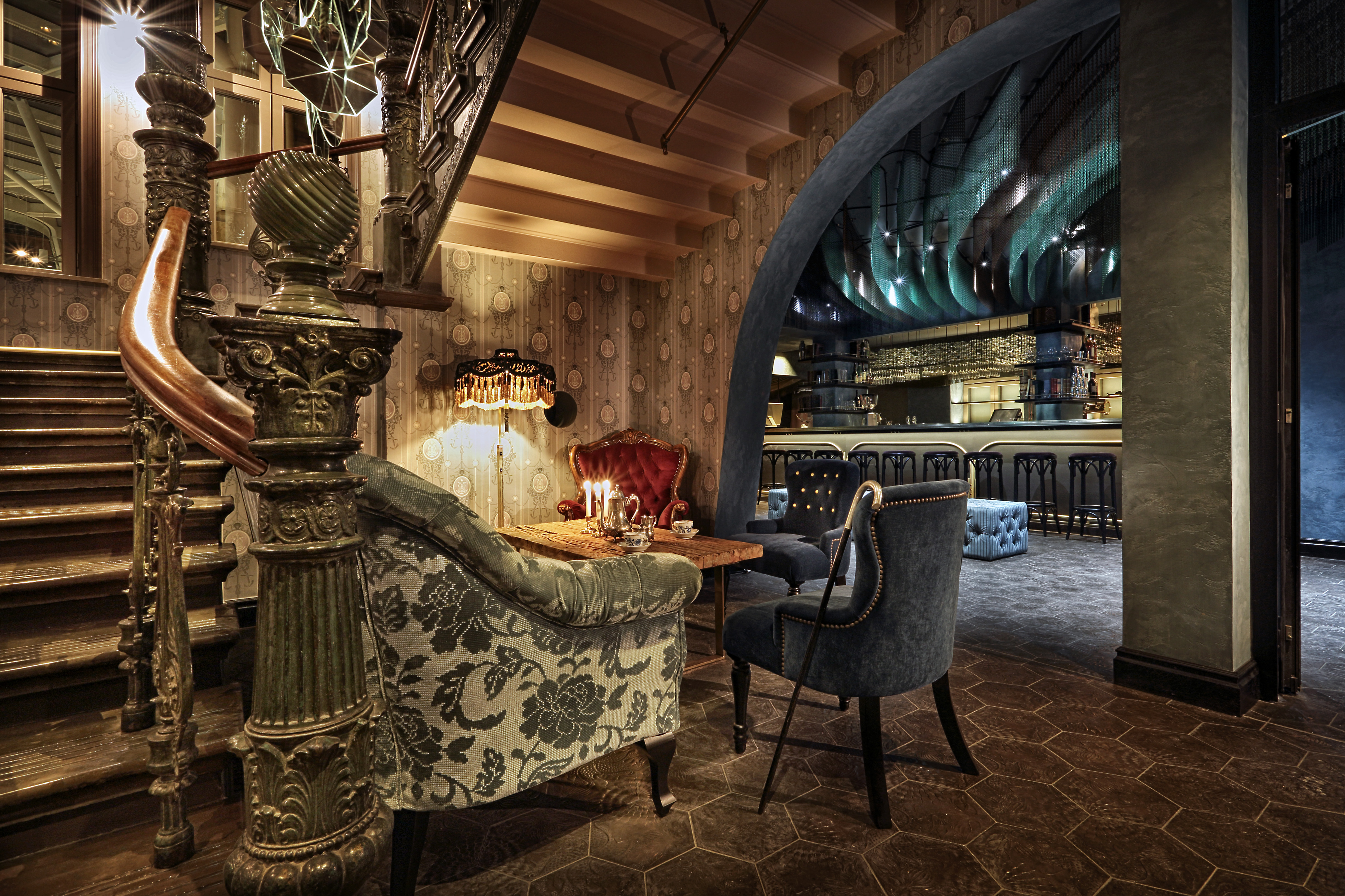 The lobby of Stora Hotellet in Umeå, featuring a grand staircase, period furnishings and a modern bar.