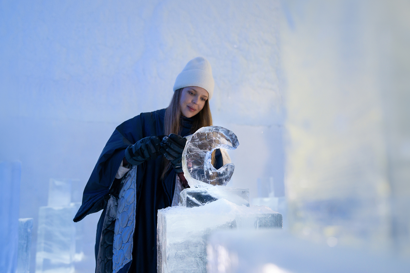 A person carves an ice sculpture inside the Icehotel in Jukkasjärvi.