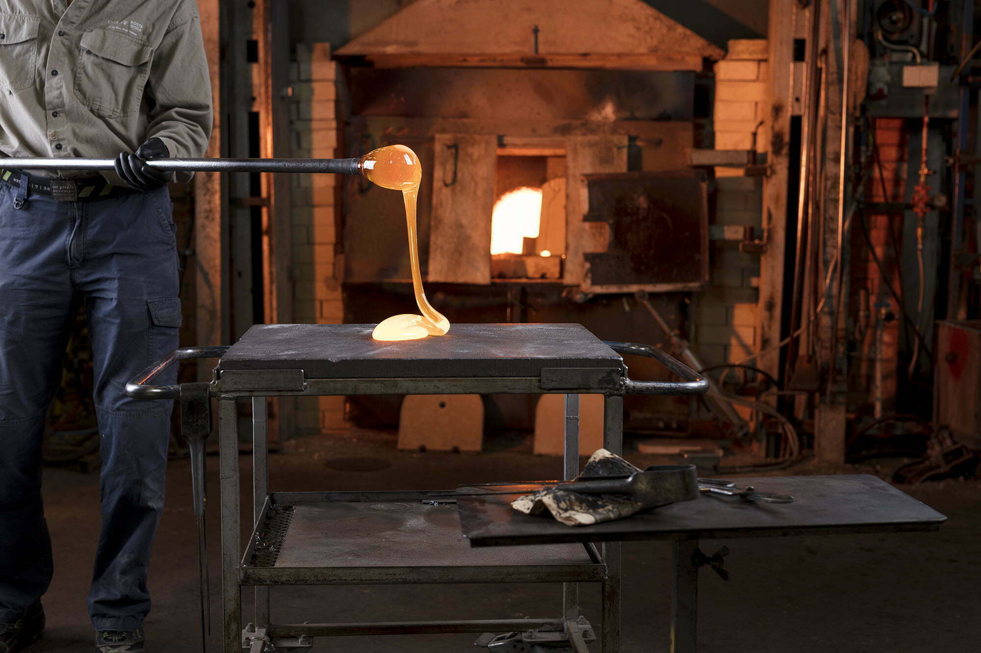 Molten glass is shaped on a blowpipe inside a glassworks in Sweden’s Kingdom of Crystal (Glasriket).