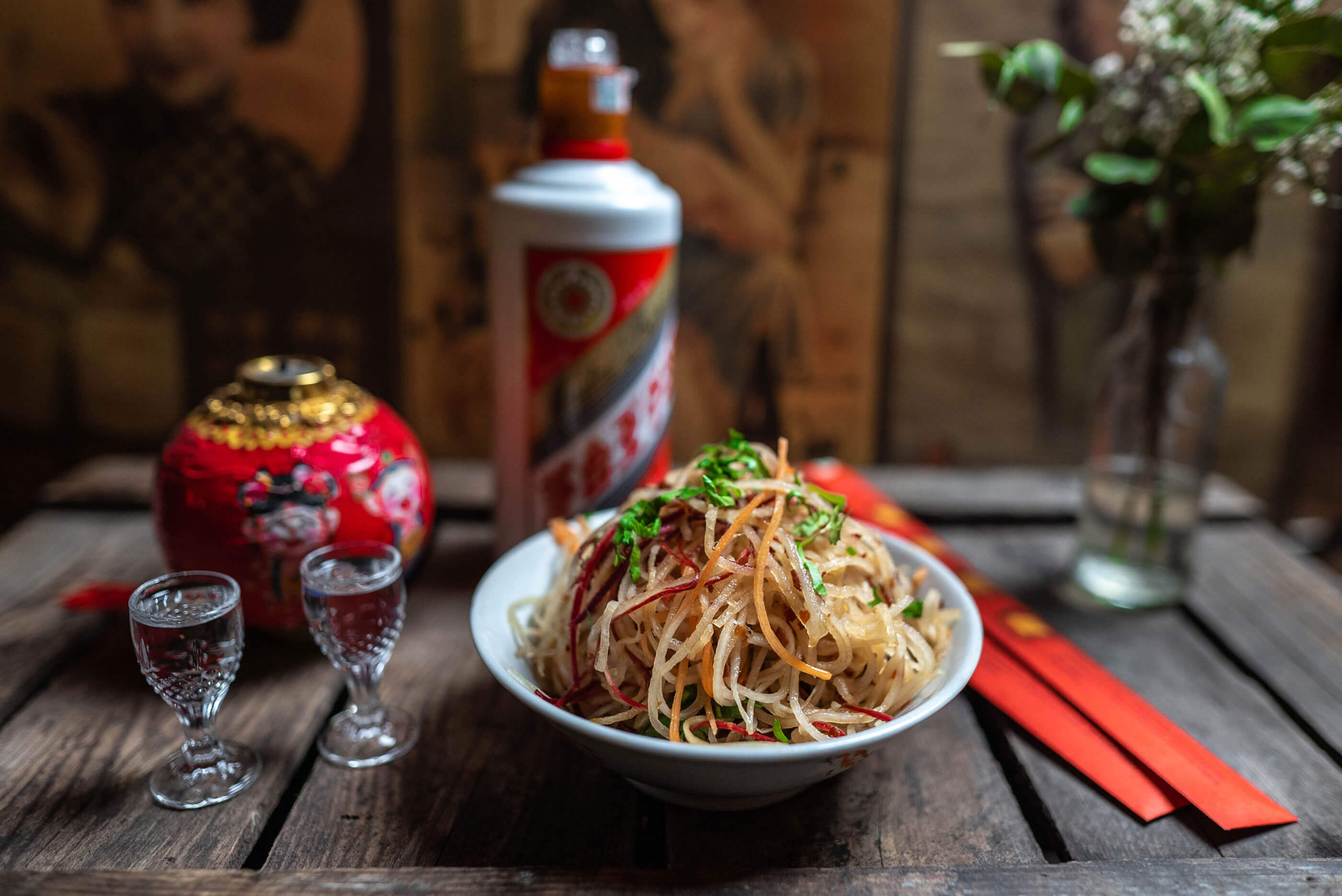 Bowl of spicy food served with Chinese spirits and decorative items at Surfers restaurant in Visby.