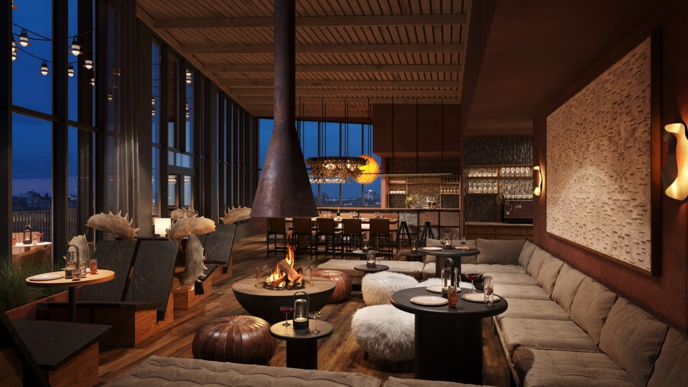 Gemütliche Lounge im Elite Hotel Frost in Kiruna mit offenem Kamin und Sofas, die abends warm beleuchtet sind.