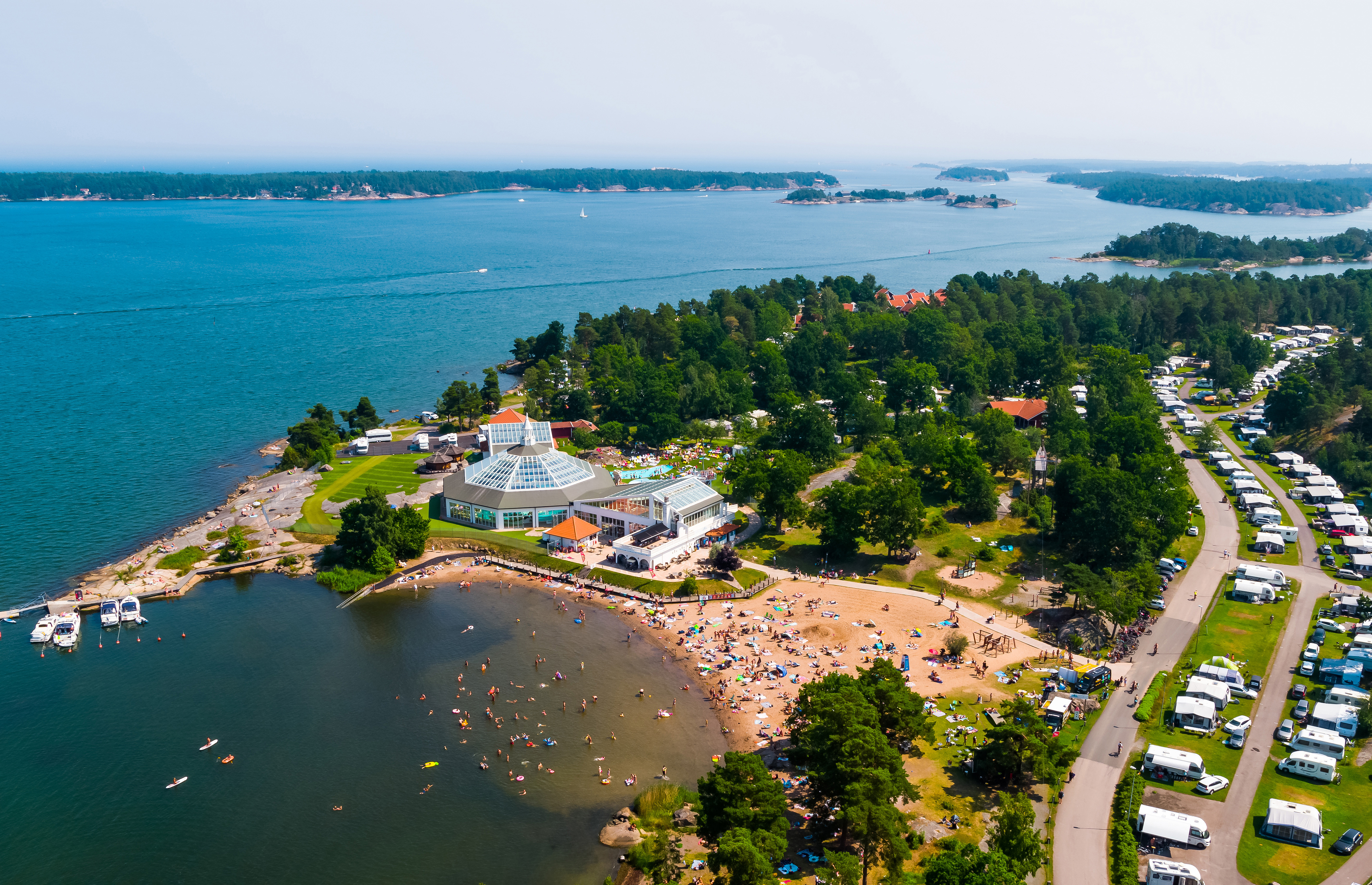 Aerial view of Västervik Resort with beach, campsite and archipelago coastline in Småland.