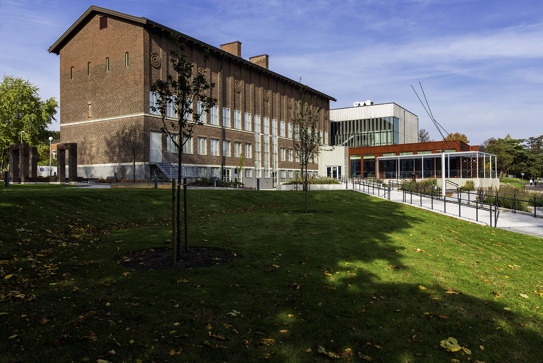 Exterior of Hallands Konstmuseum in Halmstad, showing a large red-brick building with modern extensions, surrounded by lawns and trees.